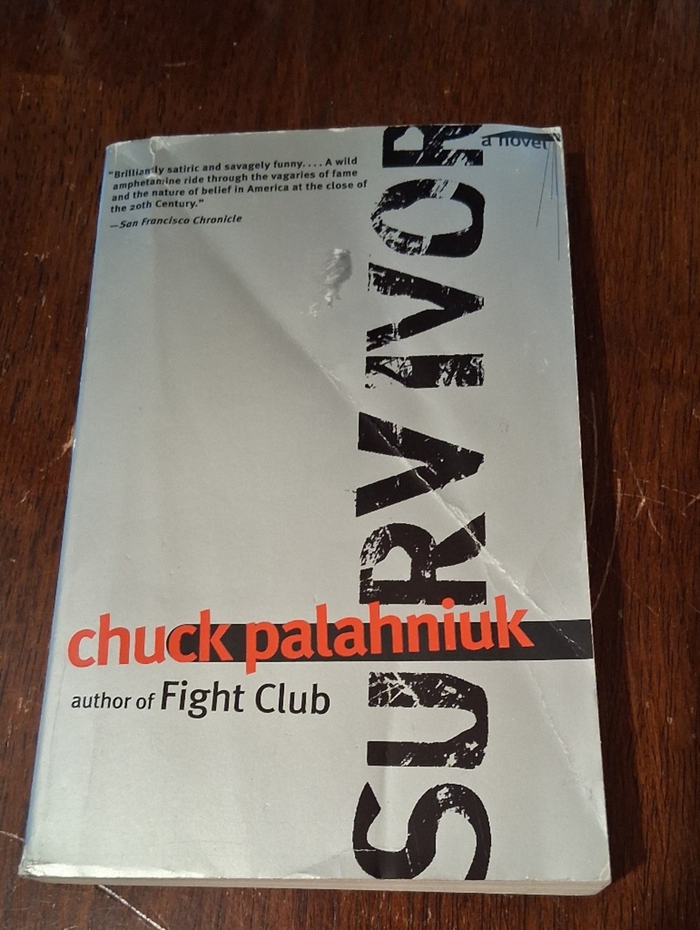 Chuck Palahniuk Paperback Book with Light Blue and Orange Cover